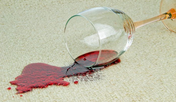 Spilled glass of red wine on a cream carpet 